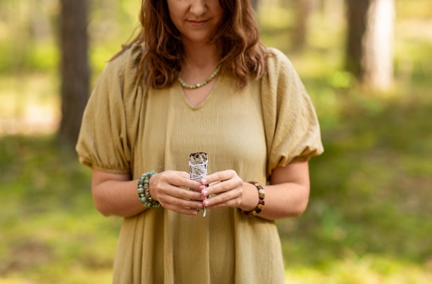 woman with sage performing magic ritual forest 380164 291477